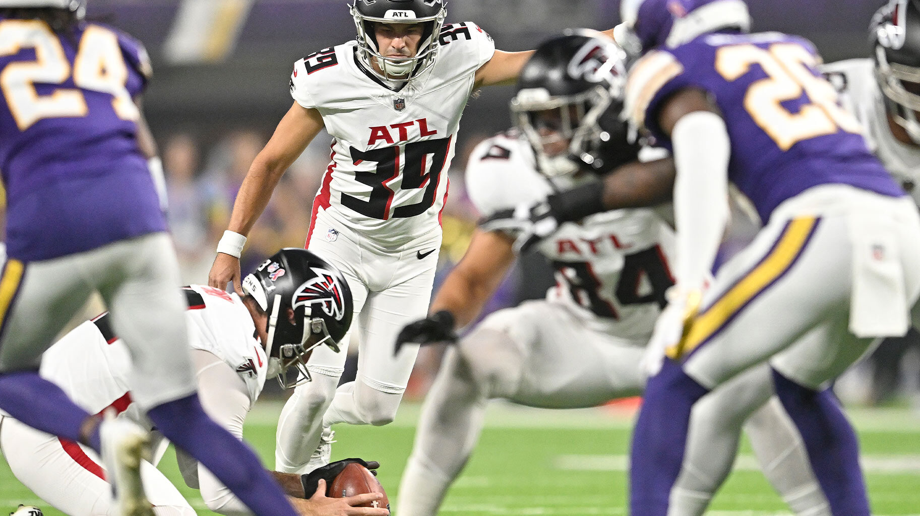 Atlanta Falcons Kicker, #39, John Parker Romo kicking a football during a game.