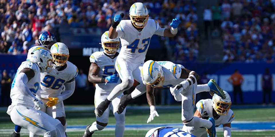 Los Angeles Chargers linebacker Troy Dye (43) and Los Angeles Chargers safety Derwin James Jr. (3) jump over New York Giants running back Devin Singletary (26) during a game at MetLife Stadium, Sep 28, 2025, East Rutherford, NJ, USA.