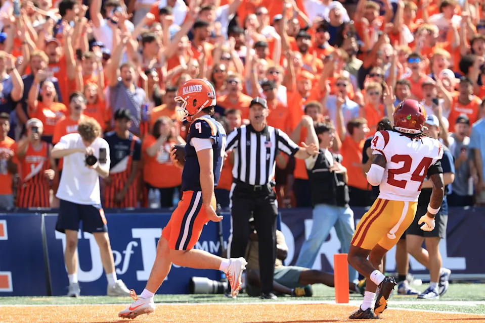 CHAMPAIGN, ILLINOIS - SEPTEMBER 27: Luke Altmyer #9 of the Illinois Fighting Illini scores a touchdown during the first quarter against the USC Trojans at Memorial Stadium on September 27, 2025 in Champaign, Illinois.