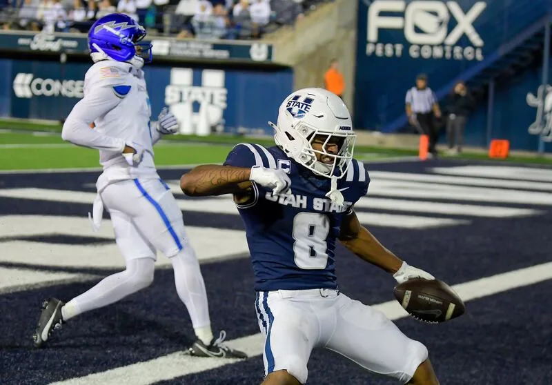 Utah State running back Javen Jacobs (8) celebrates after scoring a 52-yard touchdown against Air Force in the second half Saturday Sept. 13, 2025, in Logan, Utah. | Eli Lucero/Herald Journal