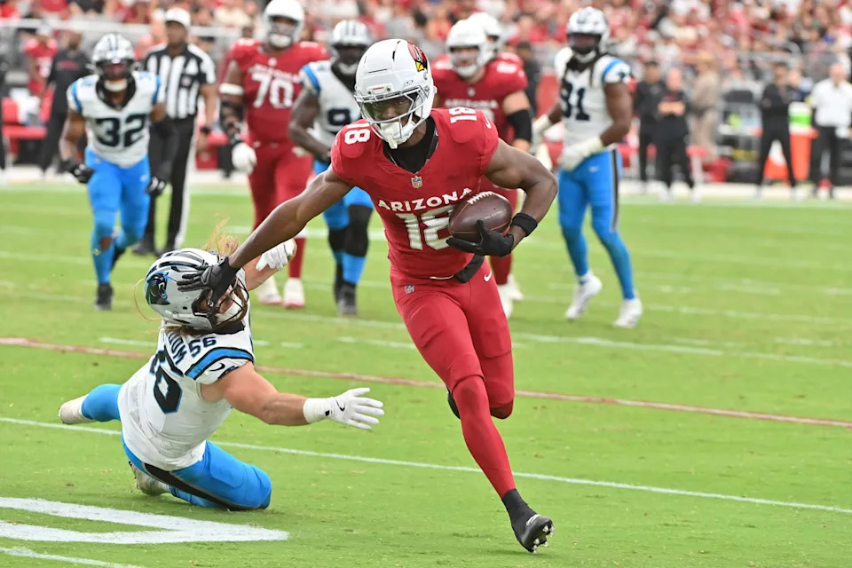 Sep 14, 2025; Glendale, Arizona, USA; Arizona Cardinals wide receiver Marvin Harrison Jr. (18) runs the ball defended by Carolina Panthers linebacker Christian Rozeboom (56) during the third quarter at State Farm Stadium. Mandatory Credit: Matt Kartozian-Imagn Images