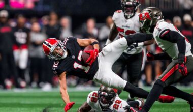 Atlanta Falcons wide receiver KhaDarel Hodge (12) is upended by Tampa Bay Buccaneers safety Christian Izien (29) during the first half of an NFL football game, Thursday, Oct. 3, 2024, in Atlanta. The Falcons defeated the Buccaneers 36-30 in overtime. (AP Photo/Danny Karnik)