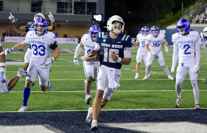 Utah State quarterback Bryson Barnes (16) scores on a 7-yard run against Air Force in the second half Saturday Sept. 13, 2025, in Logan, Utah. | Eli Lucero/Herald Journal
