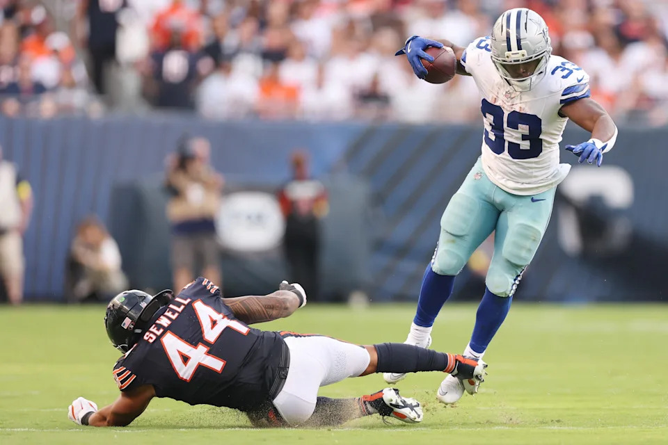CHICAGO, ILLINOIS - SEPTEMBER 21: Javonte Williams #33 of the Dallas Cowboys avoids a tackle by Noah Sewell #44 of the Chicago Bears during the fourth quarter at Soldier Field on September 21, 2025 in Chicago, Illinois. (Photo by Michael Reaves/Getty Images)