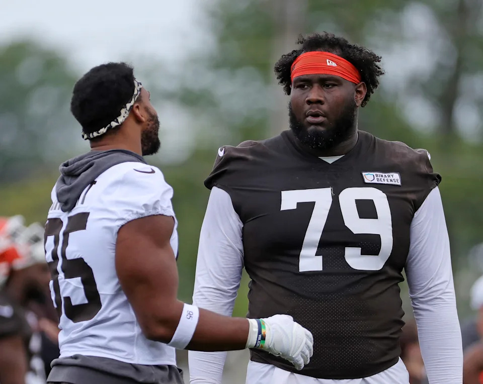 Cleveland Browns offensive tackle Dawand Jones (79) chats with defensive end Myles Garrett (95) during practice at minicamp June 10, 2025, in Berea, Ohio.