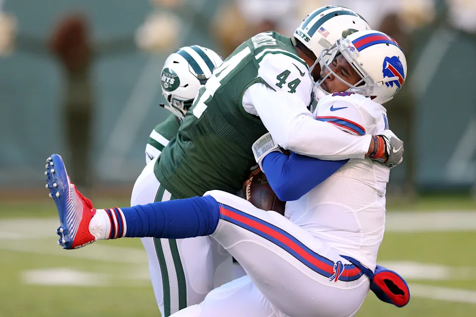 Jan 1, 2017; East Rutherford, NJ, USA; Buffalo Bills quarterback EJ Manuel (3) fumbles the ball after being sacked by New York Jets linebacker Corey Lemonier (44) and New York Jets linebacker Jordan Jenkins (48) during the third quarter at MetLife Stadium. Mandatory Credit: Brad Penner-USA TODAY Sports