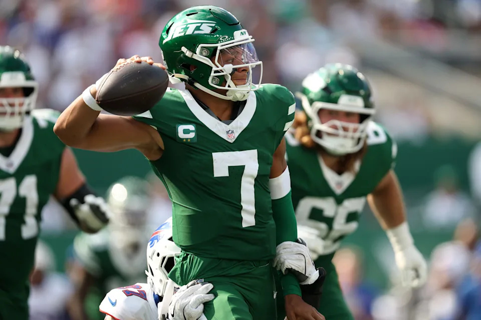 Sep 14, 2025; East Rutherford, New Jersey, USA; New York Jets quarterback Justin Fields (7) is pressured by Buffalo Bills defensive end Joey Bosa (97) during the second half at MetLife Stadium. Mandatory Credit: Vincent Carchietta-Imagn Images