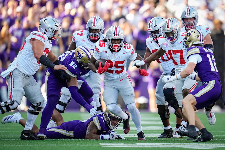 Ohio State Buckeyes running back Bo Jackson (25) runs over Washington Huskies linebacker Xe'ree Alexander (10) and defensive lineman Bryce Butler (92) during the NCAA football game at Husky Stadium in Seattle on Sept. 27, 2025. Ohio State won 24-6.