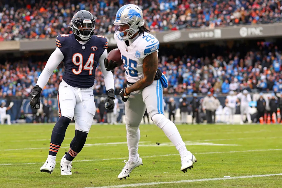 Jahmyr Gibbs of the Detroit Lions scores a touchdown while defended by Rasheem Green of the Chicago Bears during the second quarter at Soldier Field in Chicago on Sunday, Dec. 10, 2023.