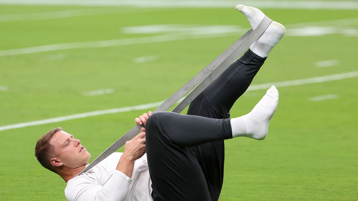 Christian McCaffrey stretches calf