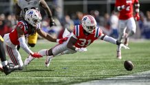 Sep 21, 2025; Foxborough, Massachusetts, USA; New England Patriots safety Craig Woodson (31) dives for the ball during the fourth quarter at Gillette Stadium. Mandatory Credit: Brian Fluharty-Imagn Images