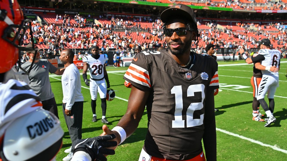 Shedeur Sanders #12 of the Cleveland Browns shakes hands on the field.