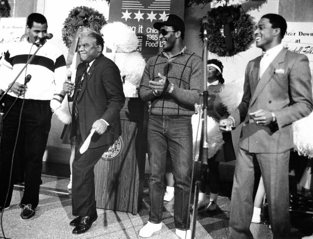 Mayor Harold Washington does his version of the "Super Bowl shuffle" at City Hall on Dec. 16, 1985, with Richard Dent, left, Otis Wilson and Willie Gault, right, of the Bears. The players appeared with the mayor to announce that a portion of the proceeds from the players' new record will be donated to the Sharing-It program. (José Moré/Chicago Tribune) 