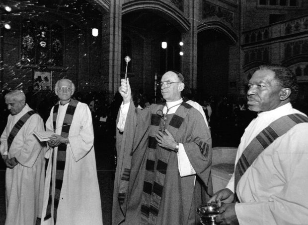 Cardinal Bernardin, center, dedicates the St. Martin de Porres Church at 5112 W. Washington Blvd. on Feb. 9, 1992, after it was completely restored. Bernardin established an independent panel to review complaints of sexual abuse by priests in 1992. (Walter Kale/Chicago Tribune)