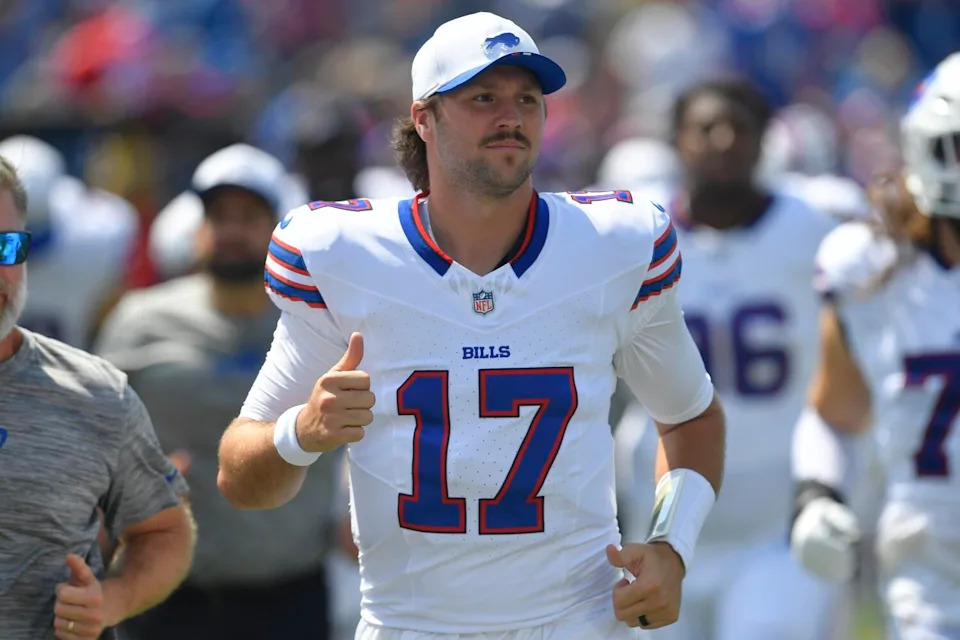 Buffalo Bills quarterback Josh Allen runs off the field at halftime during a preseason game.