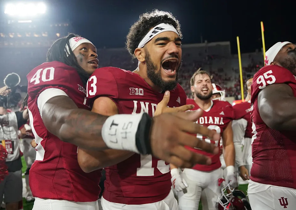 Sep 20, 2025; Bloomington, Indiana, USA; Indiana Hoosiers linebacker Quentin Clark (40) and Indiana Hoosiers wide receiver Elijah Sarratt (13) celebrate after defeating the Illinois Fighting Illini at Memorial Stadium. Mandatory Credit: Robert Goddin-Imagn Images