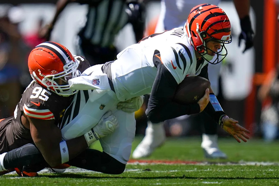 Cincinnati Bengals quarterback Joe Burrow (9) is sacked by Cleveland Browns defensive end Myles Garrett (95) in the second quarter of the NFL Week 1 game between the Cleveland Browns and the Cincinnati Bengals at Huntington Bank Field in Cleveland on Sunday, Sept. 7, 2025.