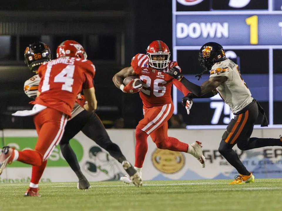  Calgary Stampeders Dedrick Mills fends off BC Lions Deontal Williams in CFL action at McMahon Stadium in Calgary, Ab., on Friday September 19, 2025. Mike Drew/Postmedia