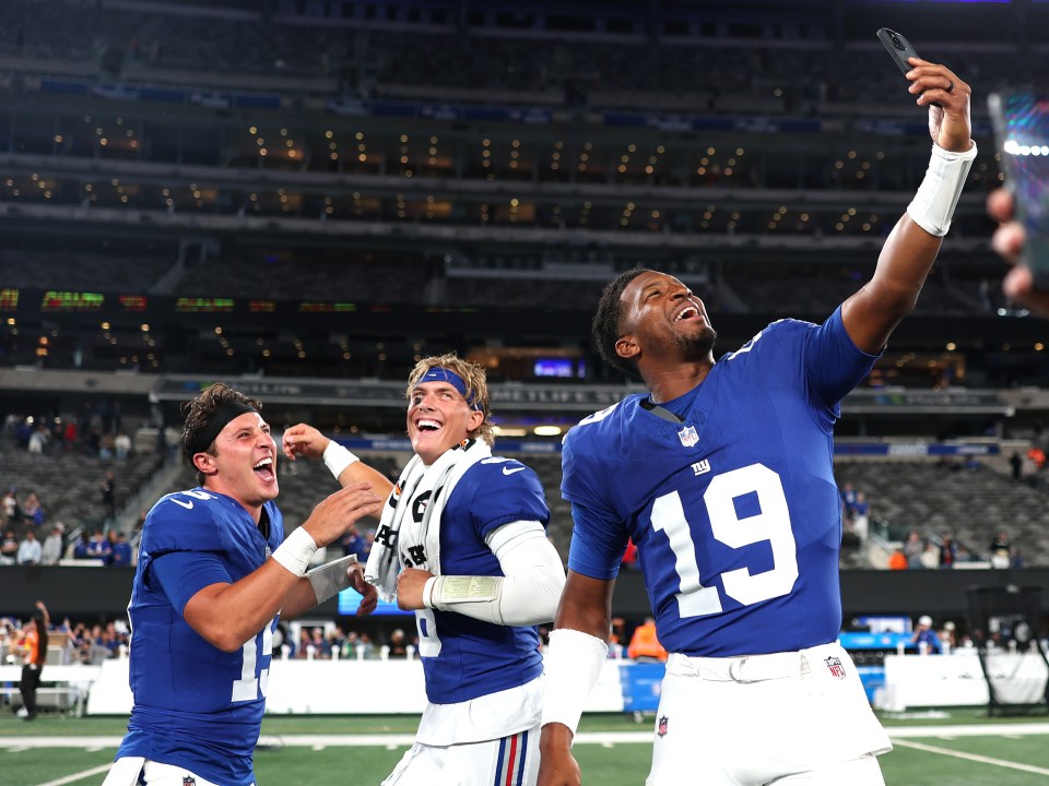 New York Giants quarterbacks Jameis Winston #19 and Tommy DeVito #15 celebrating after a preseason game.