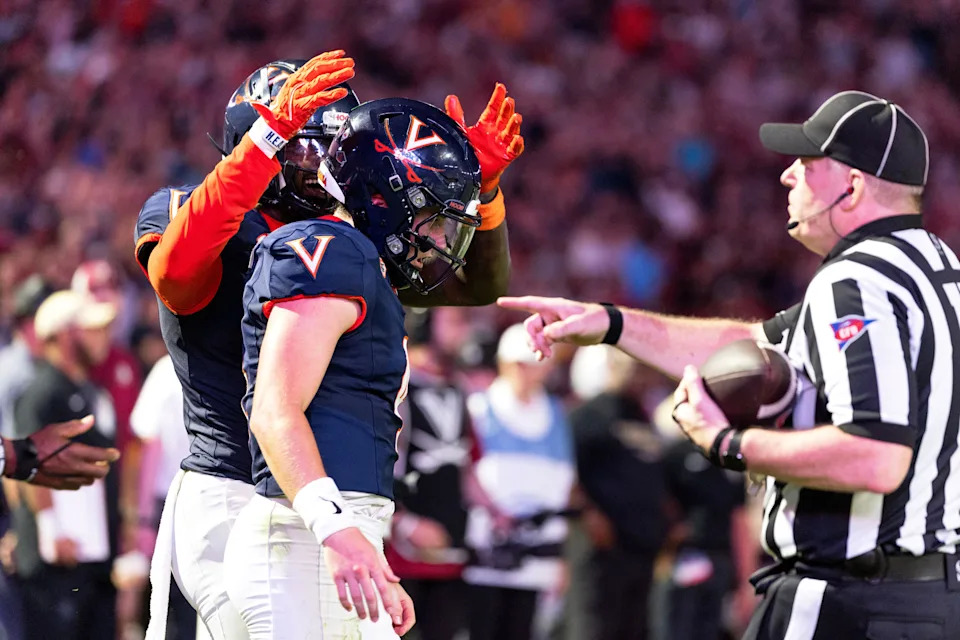 CHARLOTTESVILLE, VIRGINIA - SEPTEMBER 26: Jahmal Edrine #7 and Chandler Morris #4 of the Virginia Cavaliers celebrate a touchdown in overtime during a game against the Florida State Seminoles at Scott Stadium on September 26, 2025 in Charlottesville.