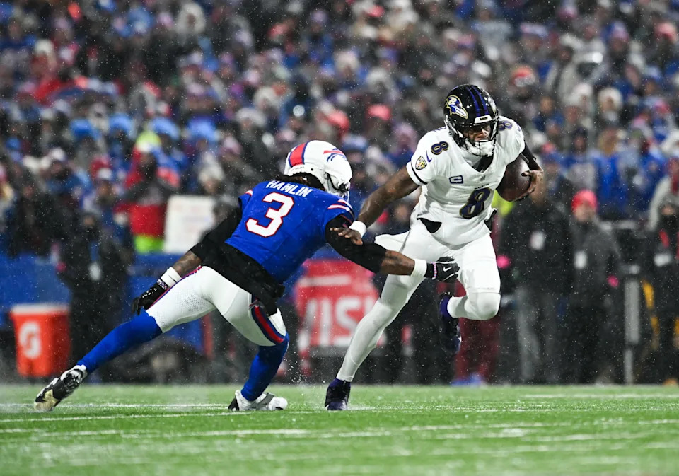 Jan 19, 2025; Orchard Park, New York, USA; Baltimore Ravens quarterback Lamar Jackson (8) runs the ball against Buffalo Bills safety Damar Hamlin (3) during the second quarter in a 2025 AFC divisional round game at Highmark Stadium. Mandatory Credit: Mark Konezny-Imagn Images