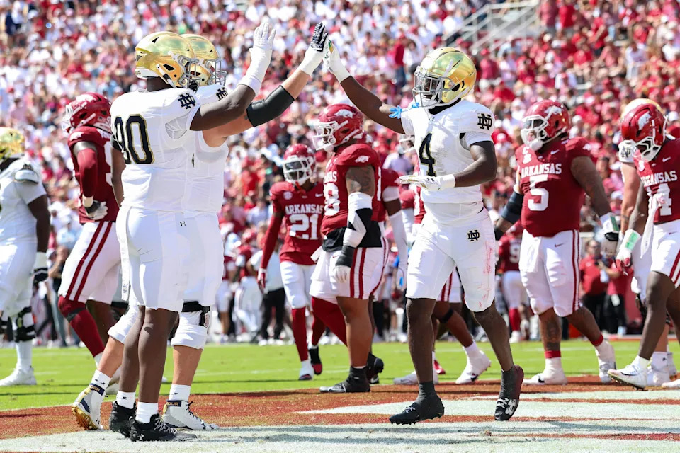 Sep 27, 2025; Fayetteville, Arkansas, USA; Notre Dame Fighting Irish running back Jeremiyah Love (4) celebrators with teammates after scoring a touchdown in the second quarter against the Arkansas Razorbacks at Donald W. Reynolds Razorback Stadium. Mandatory Credit: Nelson Chenault-Imagn Images