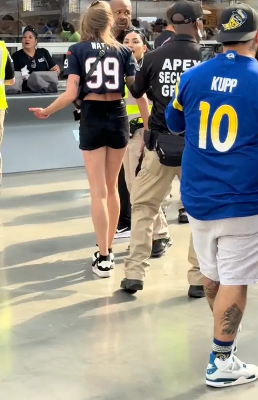 The woman is escorted away by security. @brian.bowie43/TikTok
