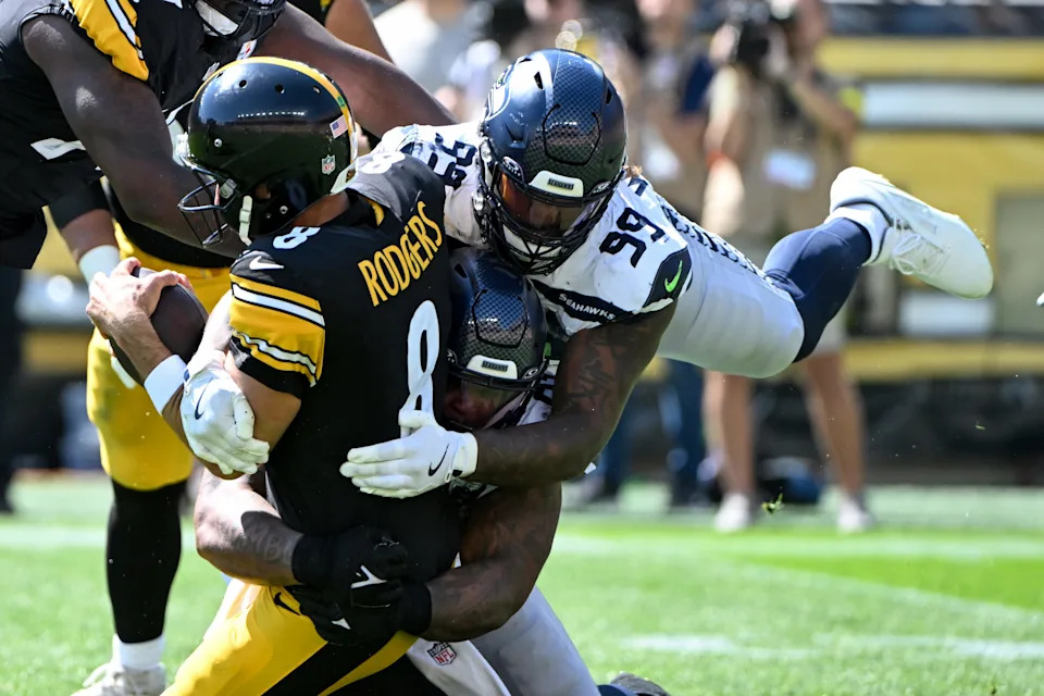 Sep 14, 2025; Pittsburgh, Pennsylvania, USA; Seattle Seahawks defensive end Leonard Williams (99) sacks Pittsburgh Steelers quarterback Aaron Rodgers (8) during the second quarter at Acrisure Stadium. Mandatory Credit: Barry Reeger-Imagn Images
