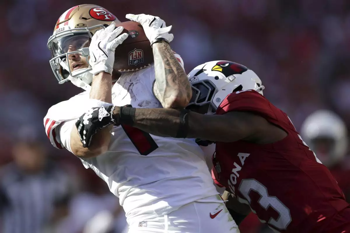 San Francisco 49ers' Ricky Pearsall, left, catches a pass against Arizona Cardinals' Kei-Trel Clark, right, in the fourth quarter of an NFL football game in Santa Clara, Calif., Sunday, Sept. 21, 2025. (Scott Strazzante/San Francisco Chronicle via AP)