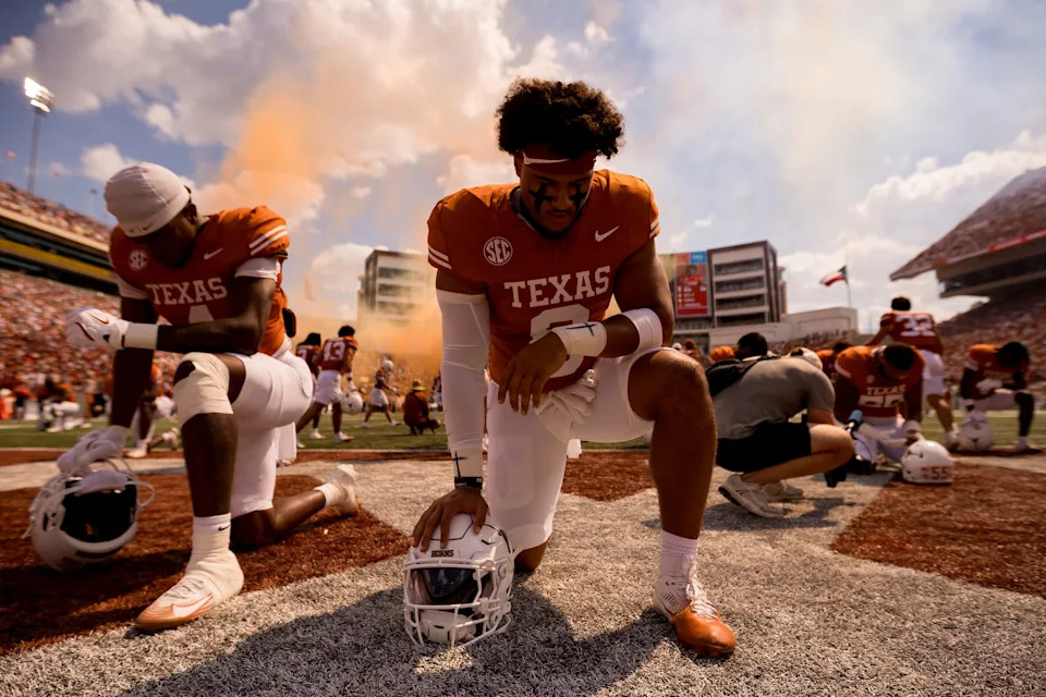 Texas Longhorn football players take a knee after taking the field for a football game against UTEP at Darrell K Royalâ€“Texas Memorial Stadium in Austin, Texas, on Saturday, Sept. 13, 2025.