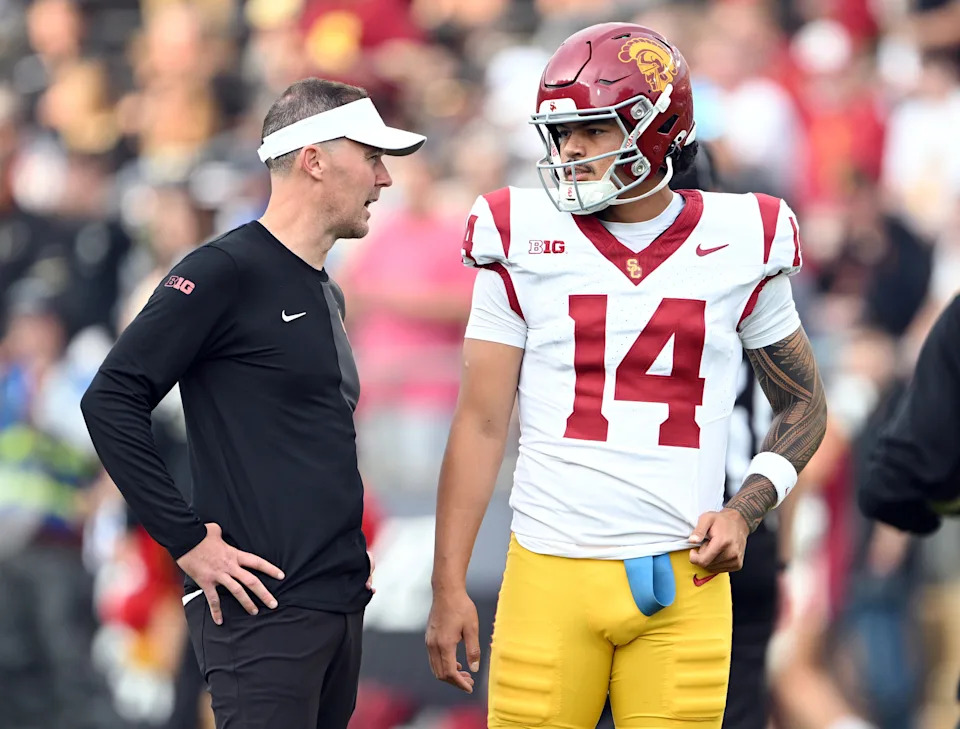 Sep 13, 2025; West Lafayette, Indiana, USA; Southern California Trojans quarterback Jayden Maiava (14) talks with Southern California Trojans head coach Lincoln Riley before the game against the Purdue Boilermakers at Ross-Ade Stadium. Mandatory Credit: Marc Lebryk-Imagn Images