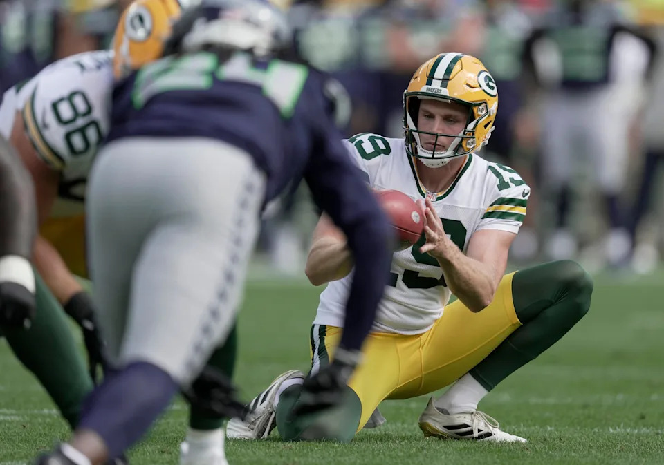 Packers punter Daniel Whelan (19) holds for an extra point during a preseason game against the Seahawks.