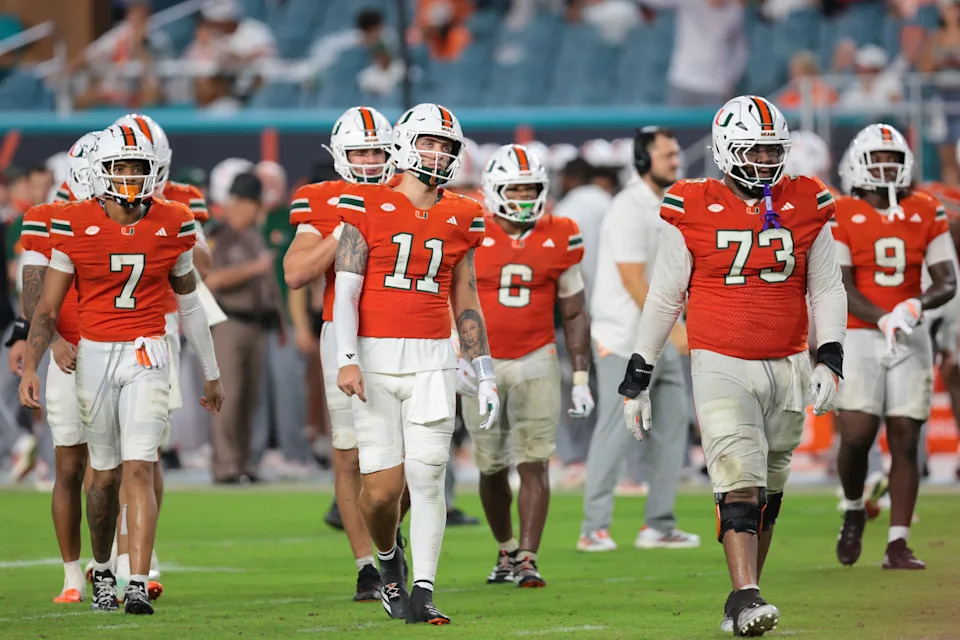 Sep 20, 2025; Miami Gardens, Florida, USA; Miami Hurricanes quarterback Carson Beck (11) and his teammates walk toward the line of scrimmage against the Florida Gators during the fourth quarter at Hard Rock Stadium.