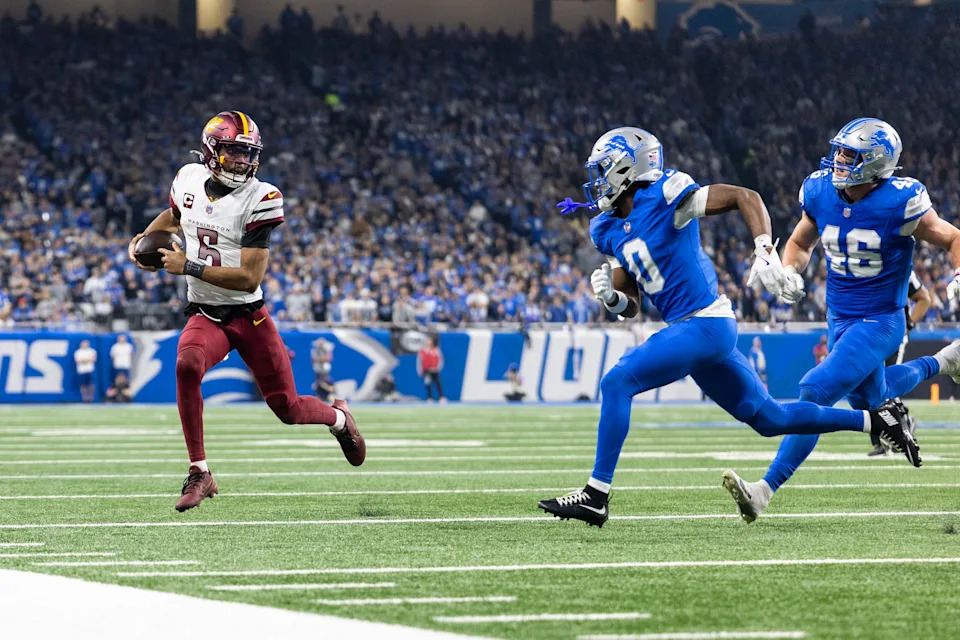 DETROIT, MICHIGAN - JANUARY 18: Jayden Daniels #5 of the Washington Commanders runs with the ball against Terrion Arnold #0 of the Detroit Lions during an NFL Football game at Ford Field on January 18, 2025 in Detroit, Michigan. (Photo by Michael Owens/Getty Images)