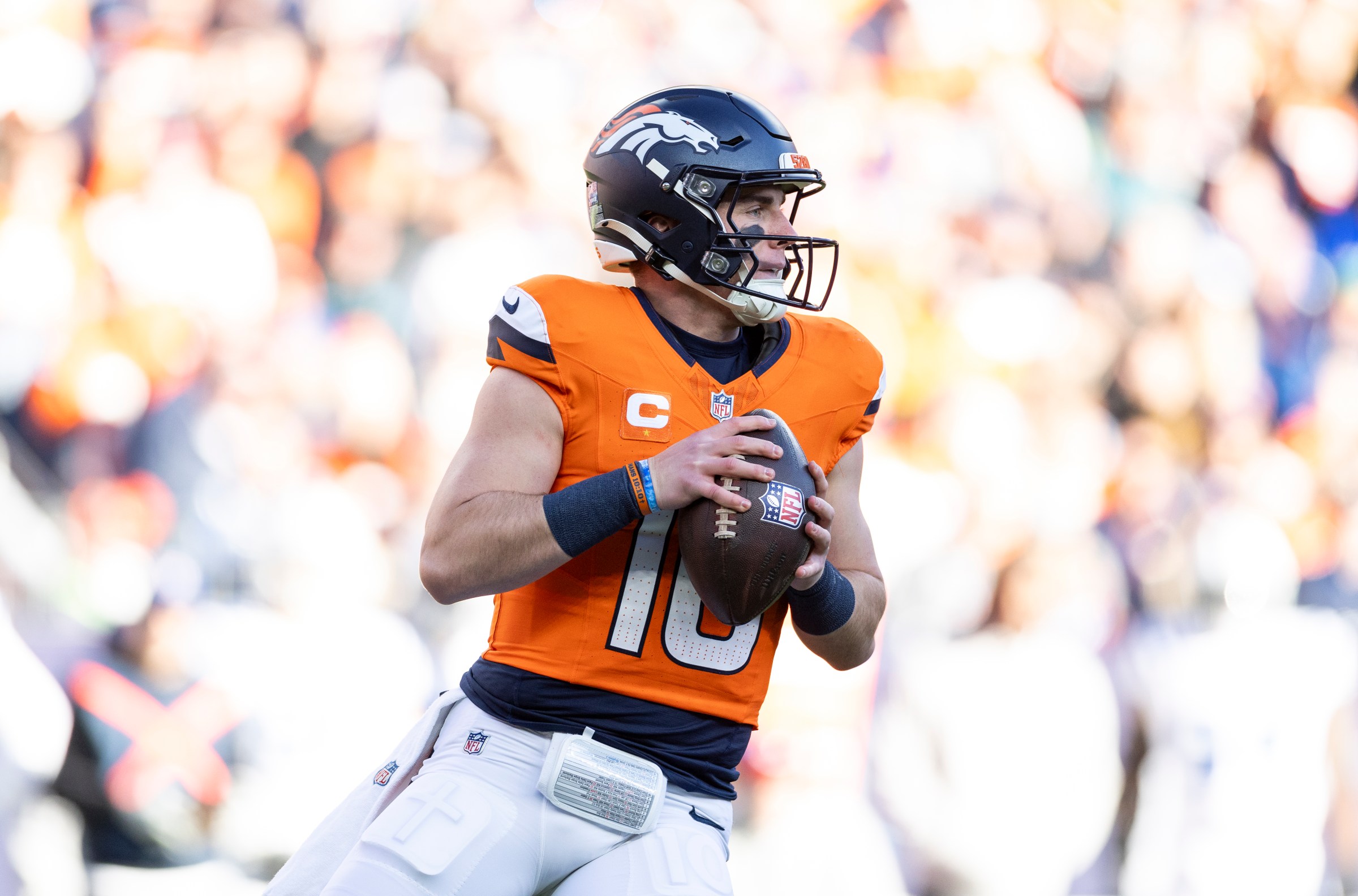 DENVER, COLORADO - DECEMBER 15: Bo Nix #10 of the Denver Broncos looks to pass during an NFL Football game against the Indianapolis Colts at Empower Field At Mile High on December 15, 2024 in Denver, Colorado. (Photo by Michael Owens/Getty Images)