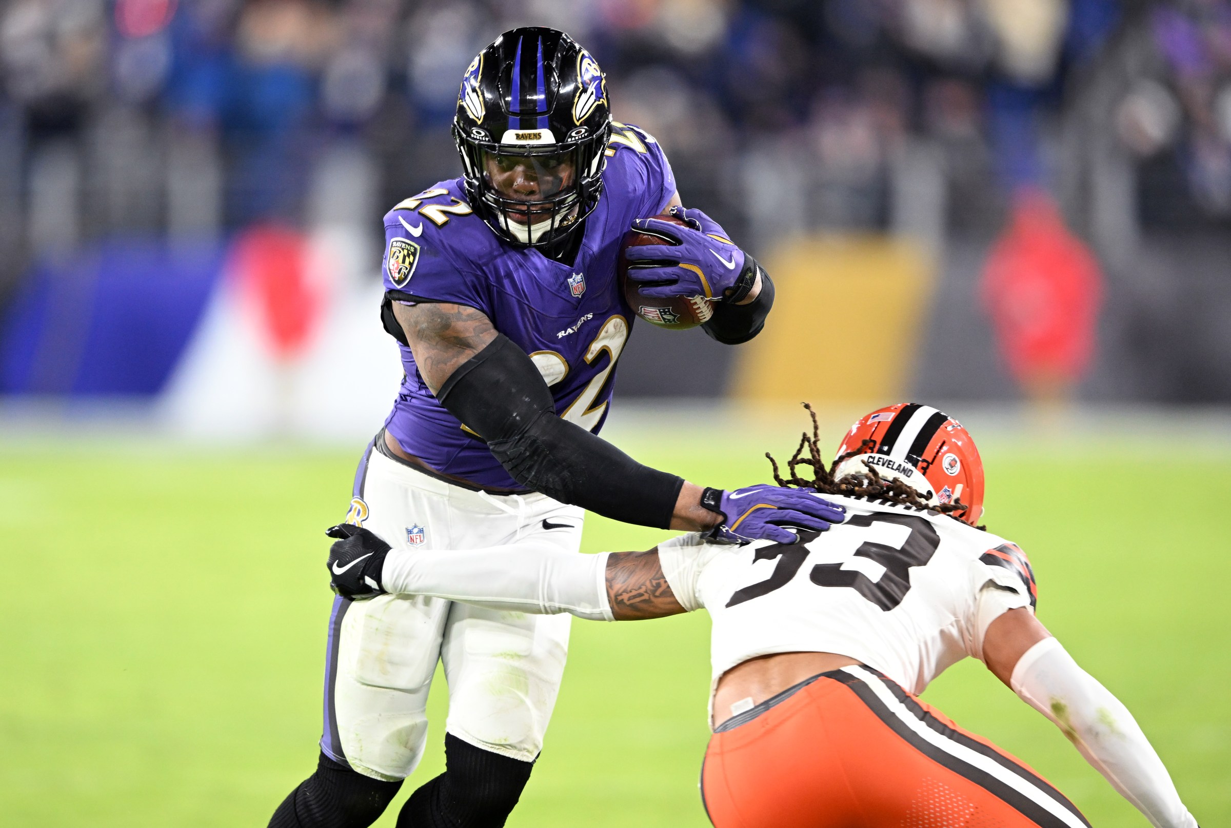 BALTIMORE, MARYLAND - JANUARY 04: Derrick Henry #22 of the Baltimore Ravens runs the ball while defended by Ronnie Hickman #33 of the Cleveland Browns during the fourth quarter at M&T Bank Stadium on January 04, 2025 in Baltimore, Maryland. (Photo by Greg Fiume/Getty Images)