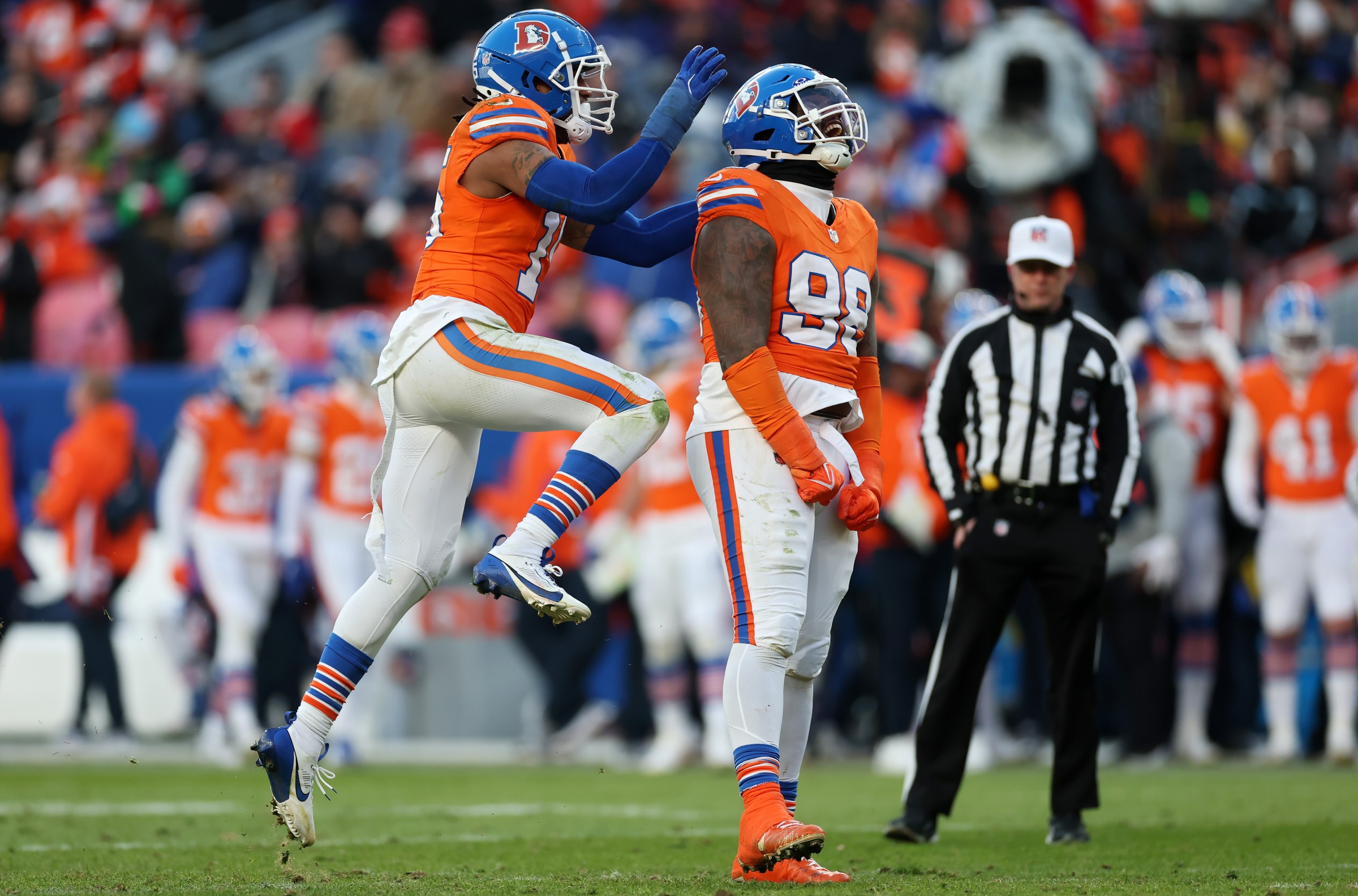 DENVER, COLORADO - JANUARY 05: Nik Bonitto #15 and John Franklin-Myers #98 of the Denver Broncos celebrate in the third quarter against the Kansas City Chiefs at Empower Field At Mile High on January 05, 2025 in Denver, Colorado. (Photo by Matthew Stockman/Getty Images)