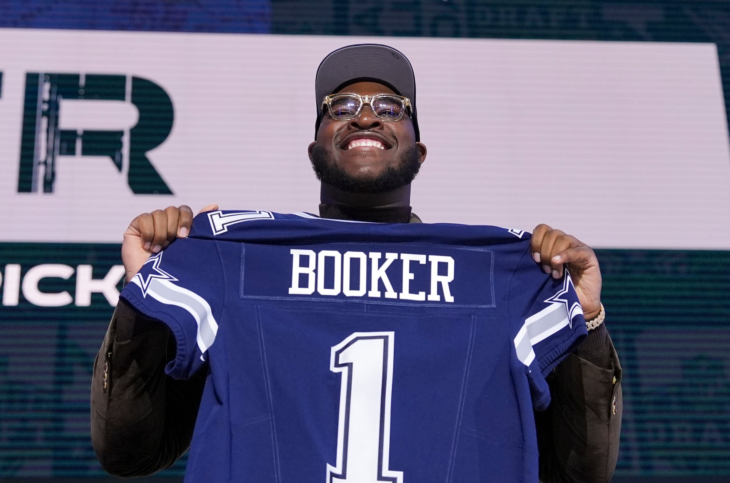 GREEN BAY, WISCONSIN - APRIL 24: Alabama offensive lineman Tyler Booker poses after being selected 12th overall by the Dallas Cowboys during the first round of the 2025 NFL Draft on April 24, 2025 in Green Bay, Wisconsin. (Photo by Perry Knotts/Getty Images)