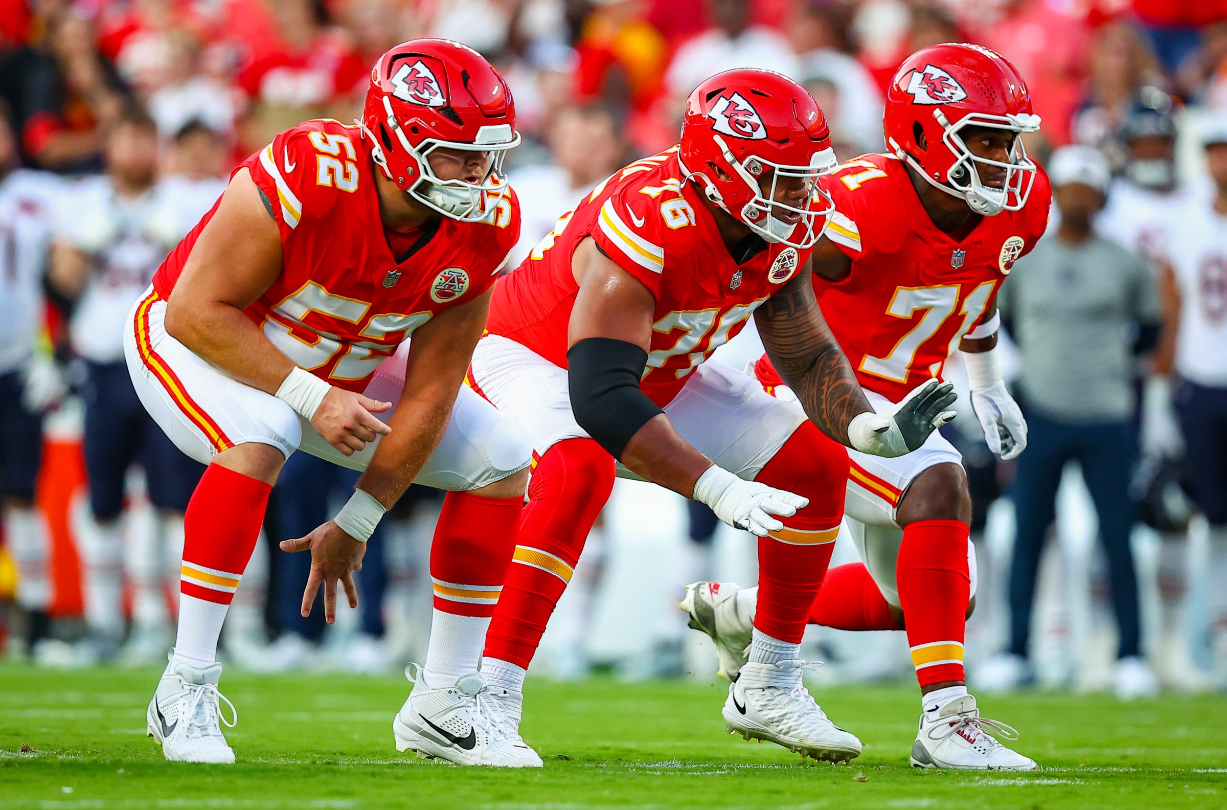 KANSAS CITY, MISSOURI - AUGUST 22: Creed Humphrey #52 of the Kansas City Chiefs, Kingsley Suamataia #76 of the Kansas City Chiefs and Josh Simmons #71 of the Kansas City Chiefs prepare to block during the first quarter during the NFL Preseason 2025 game between Chicago Bears and Kansas City Chiefs at Arrowhead Stadium on August 22, 2025 in Kansas City, Missouri. (Photo by David Eulitt/Getty Images)