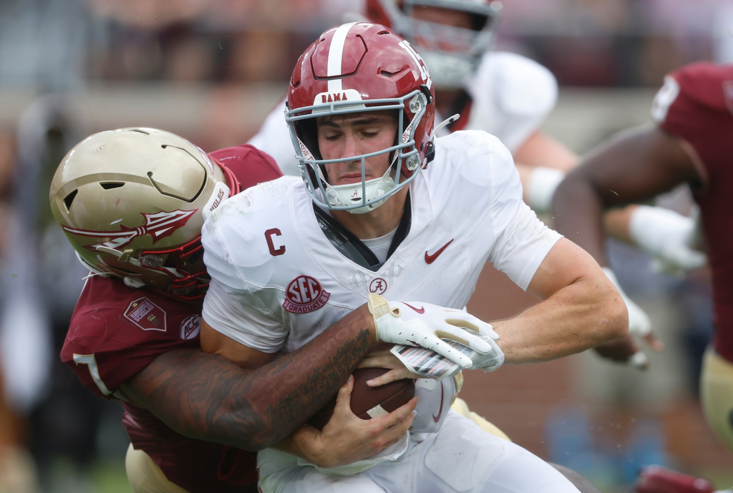 TALLAHASSEE, FLORIDA - AUGUST 30: Ty Simpson #15 of the Alabama Crimson Tide is sacked by Stefon Thompson #7 of the Florida State Seminoles during the third quarter of a football game at Doak Campbell Stadium on August 30, 2025 in Tallahassee, Florida. (Photo by Butch Dill/Getty Images)