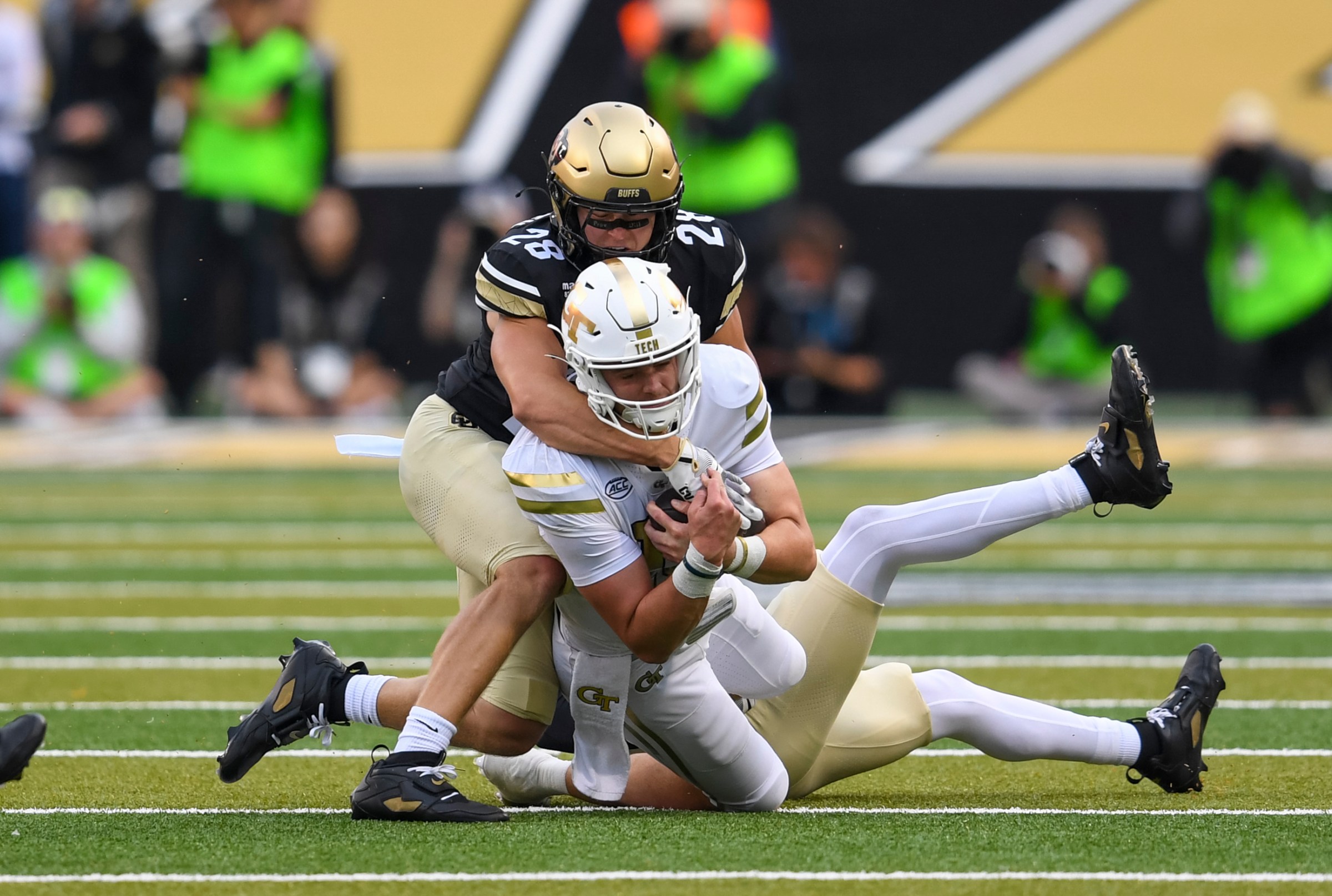 BOULDER, CO - AUGUST 29: Quarterback Haynes King #10 of the Georgia Tech Yellow Jackets, is pulled down by Safety Ben Finneseth #28 of the Colorado Buffaloes, during the college football game between the Georgia Tech Yellowjackets and the Colorado Buffaloes on August 29, 2025 at Folsom Field in Boulder, CO. (Photo by Kevin Langley/Icon Sportswire via Getty Images)