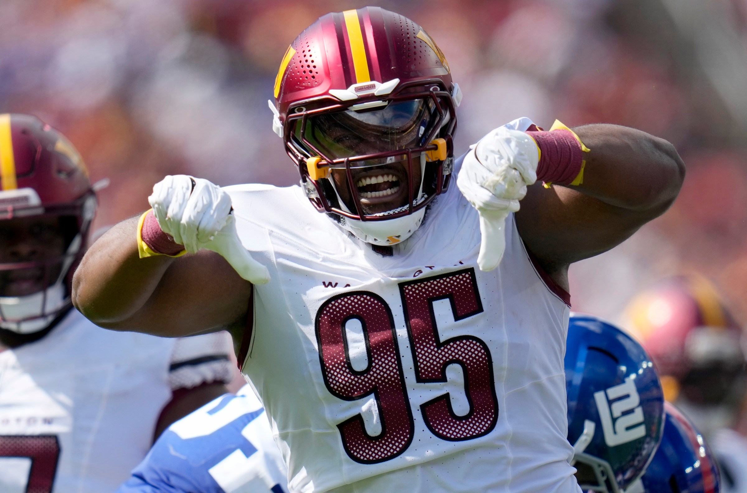 LANDOVER, MARYLAND - SEPTEMBER 07: Jer’Zhan Newton #95 of the Washington Commanders celebrates a tackle against the New York Giants during the third quarter of the NFL 2025 game at Northwest Stadium on September 07, 2025 in Landover, Maryland. (Photo by Jess Rapfogel/Getty Images)