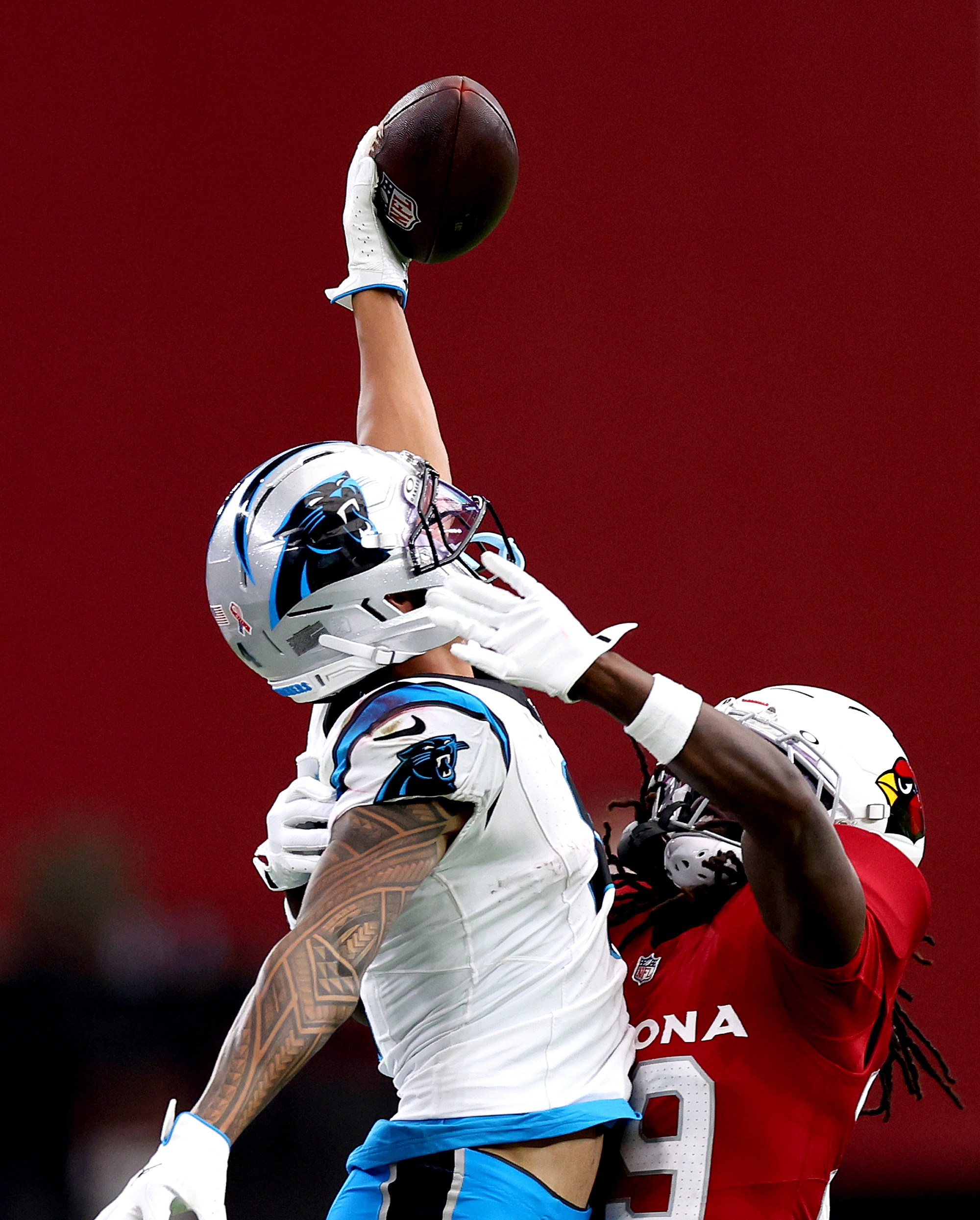 GLENDALE, ARIZONA - SEPTEMBER 14: Tetairoa McMillan #4 of the Carolina Panthers attempts to catch a pass over Denzel Burke #29 of the Arizona Cardinals during the fourth quarter at State Farm Stadium on September 14, 2025 in Glendale, Arizona. (Photo by Chris Coduto/Getty Images)