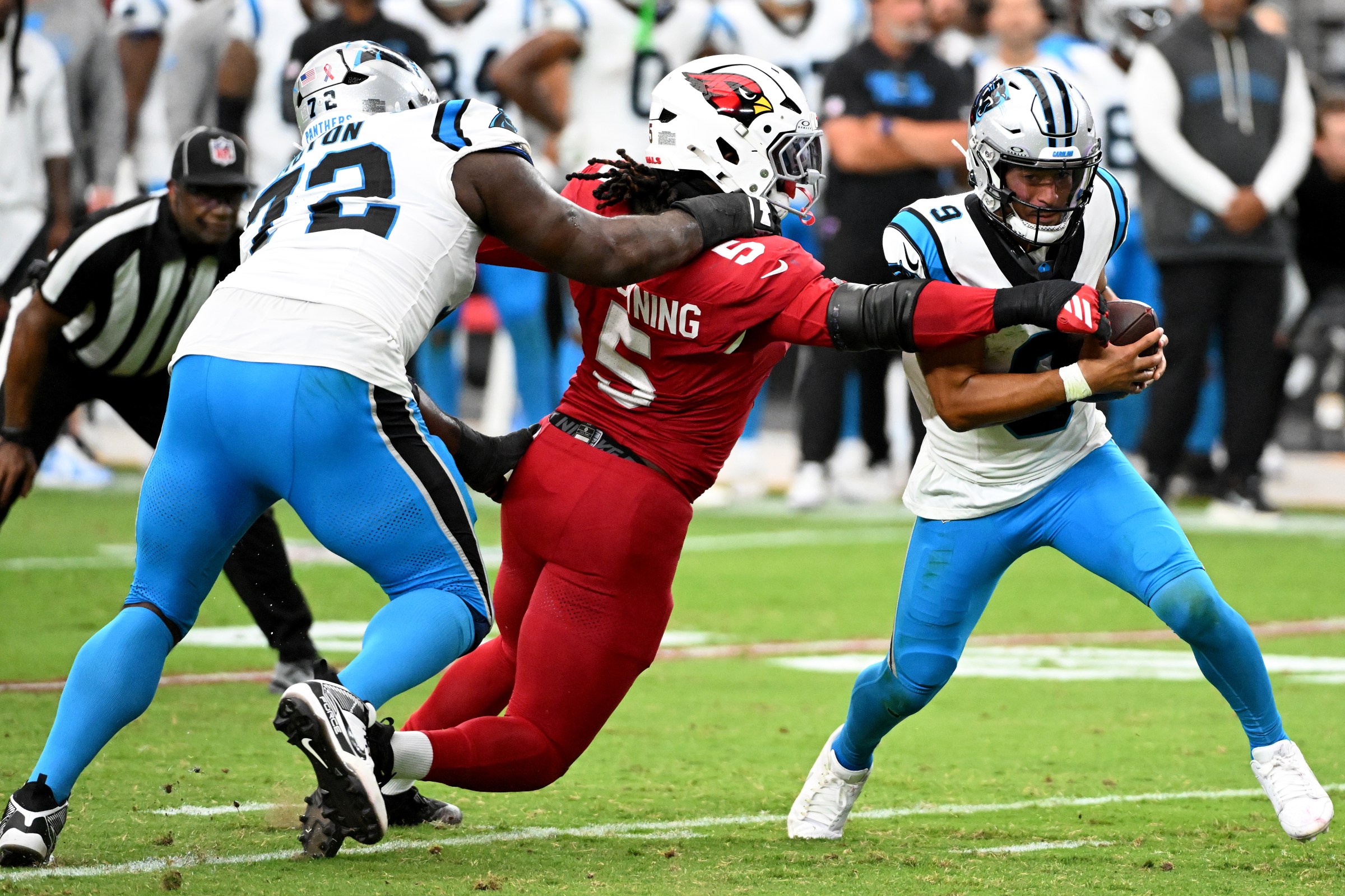 GLENDALE, ARIZONA - SEPTEMBER 14: Bryce Young #9 of the Carolina Panthers breaks a tackle from Baron Browning #5 of the Arizona Cardinals during the fourth quarter at State Farm Stadium on September 14, 2025 in Glendale, Arizona. (Photo by Norm Hall/Getty Images)