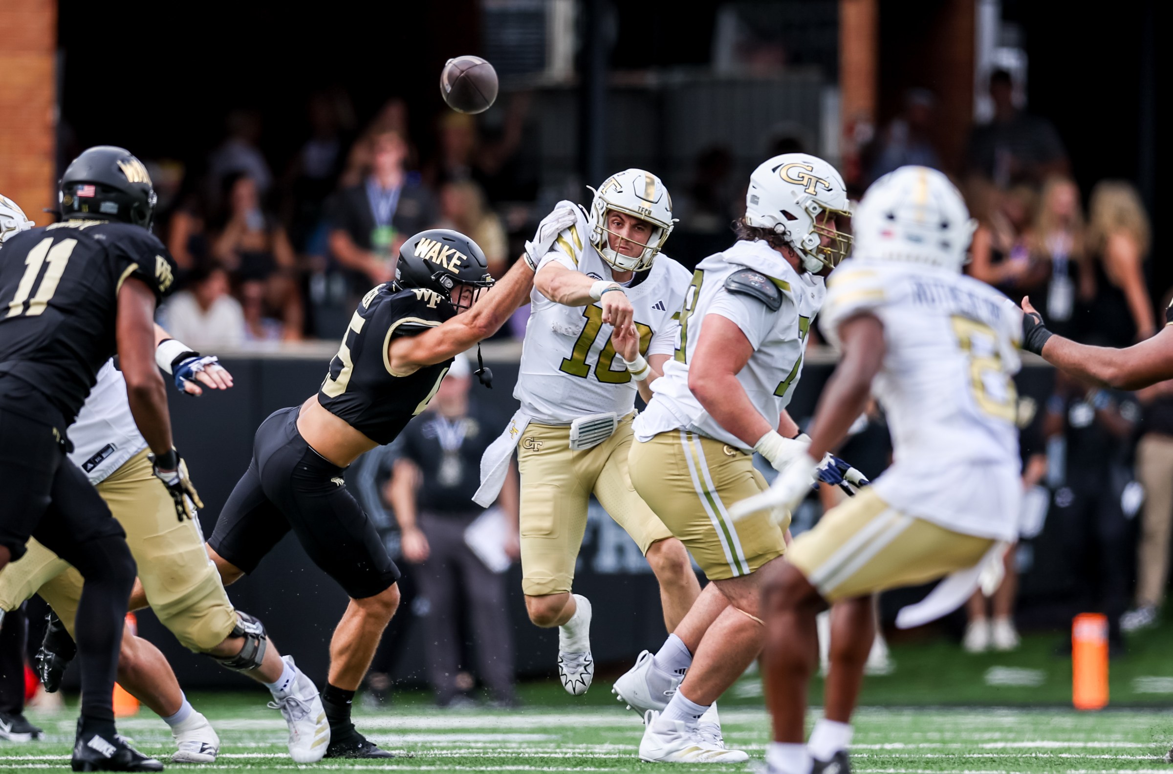 WINSTON-SALEM, NORTH CAROLINA - SEPTEMBER 27: Haynes King #10 of the Georgia Tech Yellow Jackets gets hit as he passes the ball during the first half of a football game against the Wake Forest Demon Deacons at Allegacy Federal Credit Union Stadium on September 27, 2025 in Winston-Salem, North Carolina. (Photo by David Jensen/Getty Images)