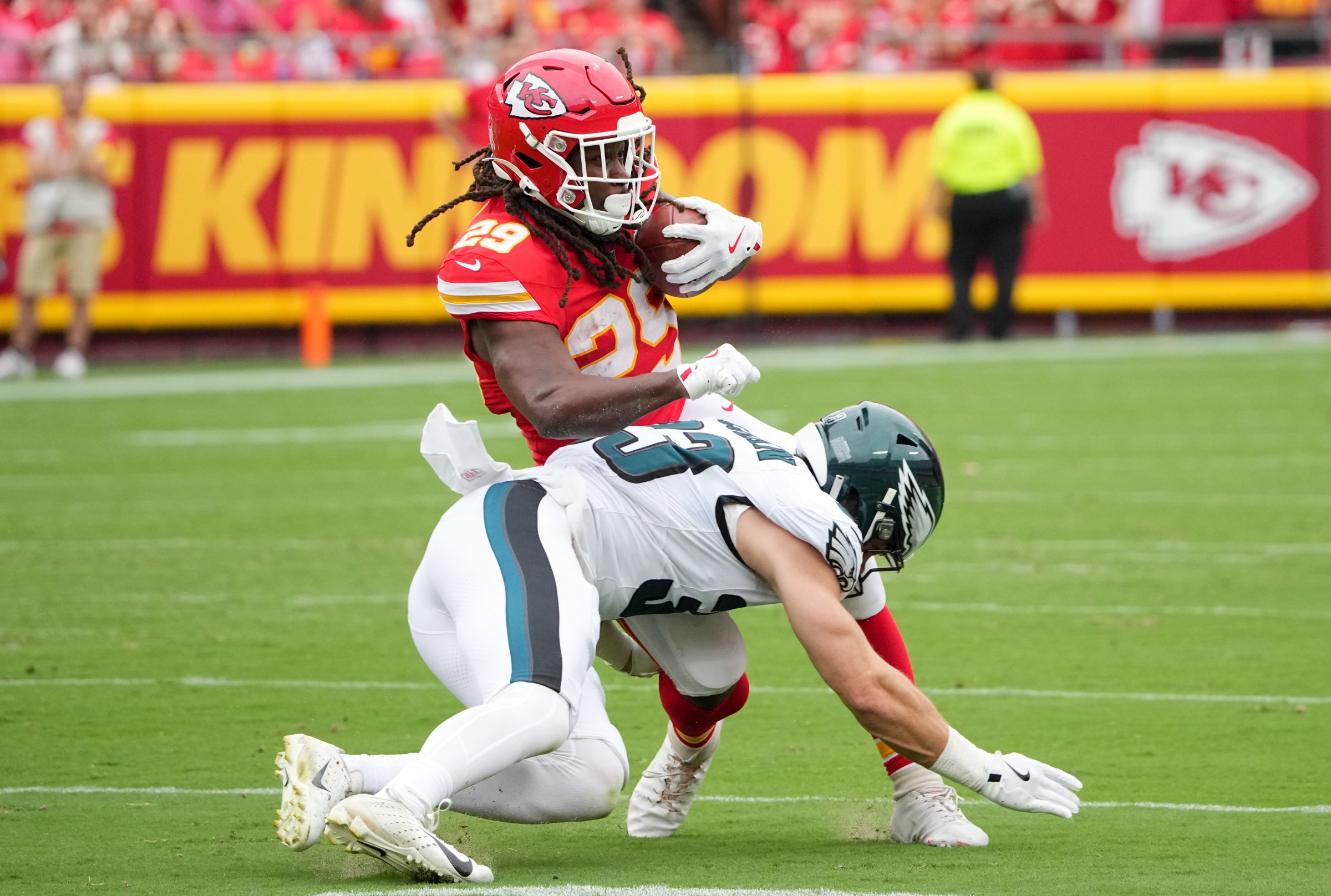 Sep 14, 2025; Kansas City, Missouri, USA; Philadelphia Eagles cornerback Cooper DeJean (33) tackles Kansas City Chiefs running back Kareem Hunt (29) during the second quarter of the game at GEHA Field at Arrowhead Stadium. Mandatory Credit: Denny Medley-Imagn Images