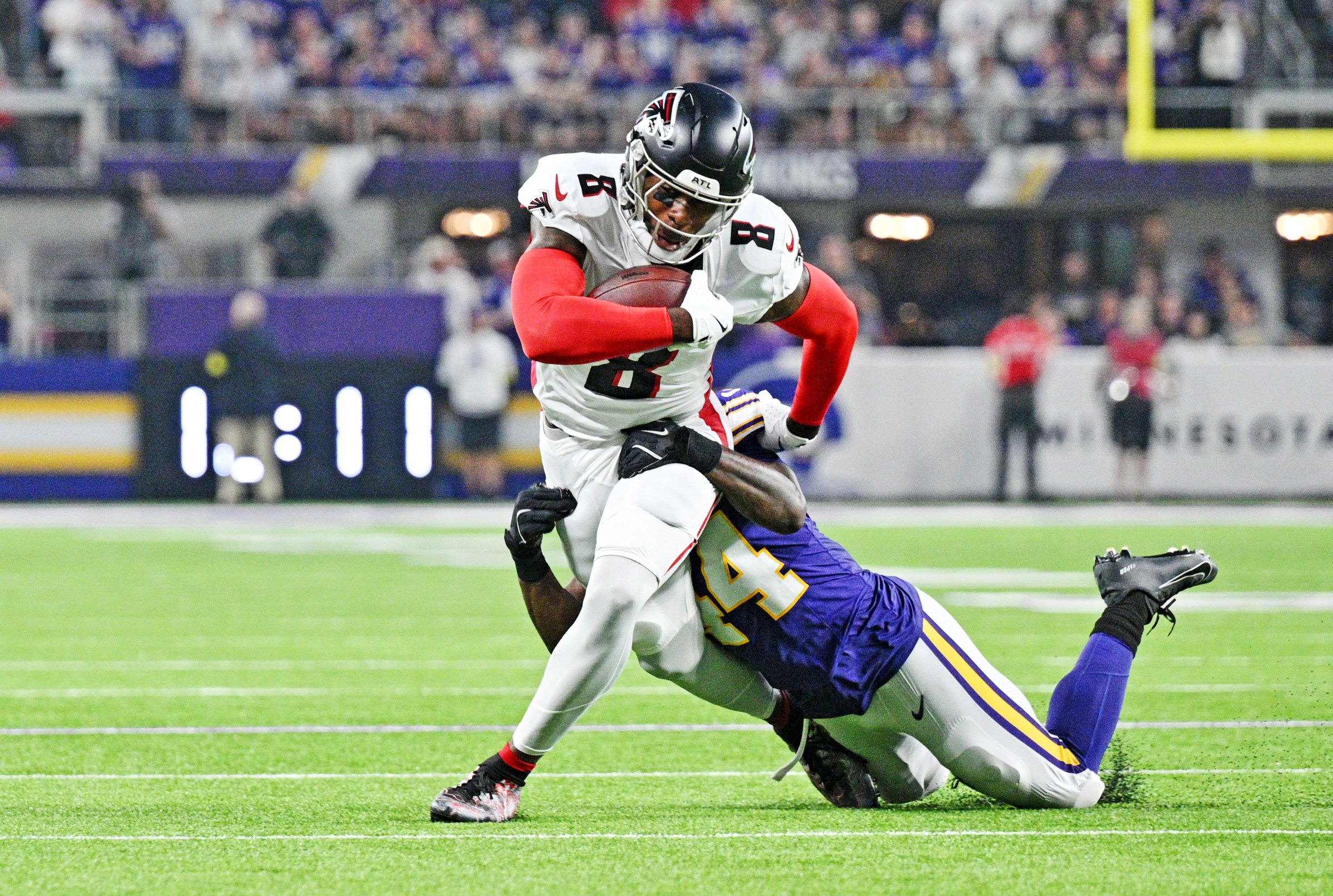 Sep 14, 2025; Minneapolis, Minnesota, USA; Minnesota Vikings safety Joshua Metellus (44) tackles Atlanta Falcons tight end Kyle Pitts Sr. (8) during the first half at U.S. Bank Stadium. Mandatory Credit: Jeffrey Becker-Imagn Images