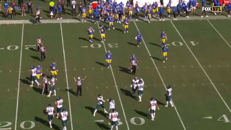 An NFL referee punishing Jalen Carter during a game between the Eagles and Rams.