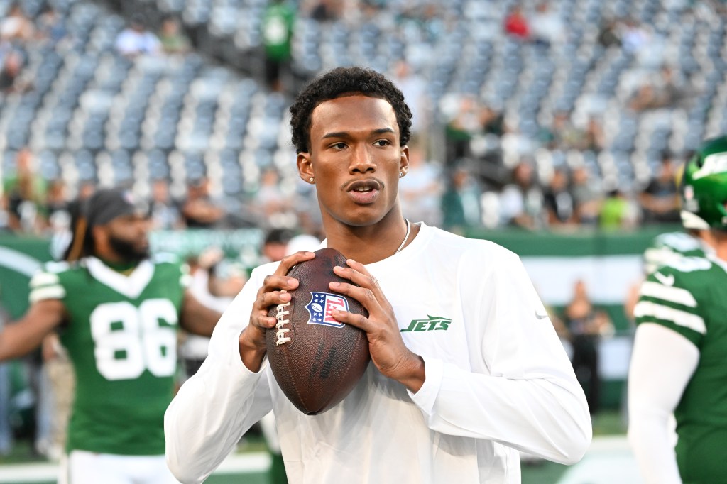 Garrett Wilson, Jets wide receiver, holding a football.