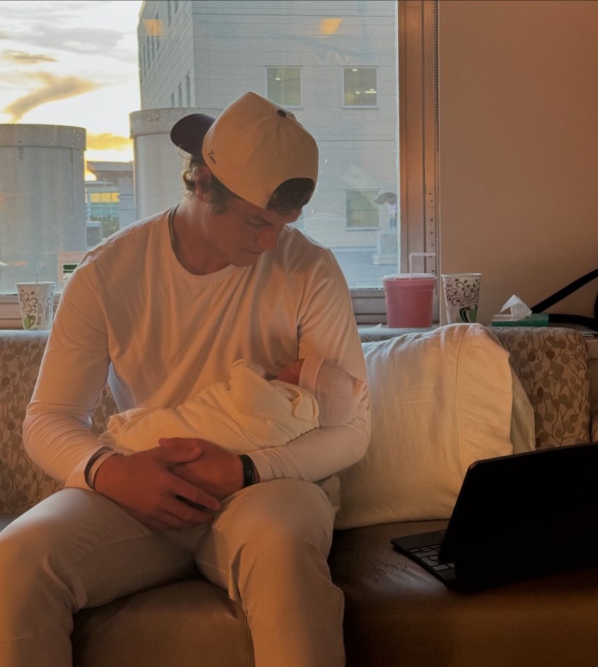 Man holding a newborn baby.